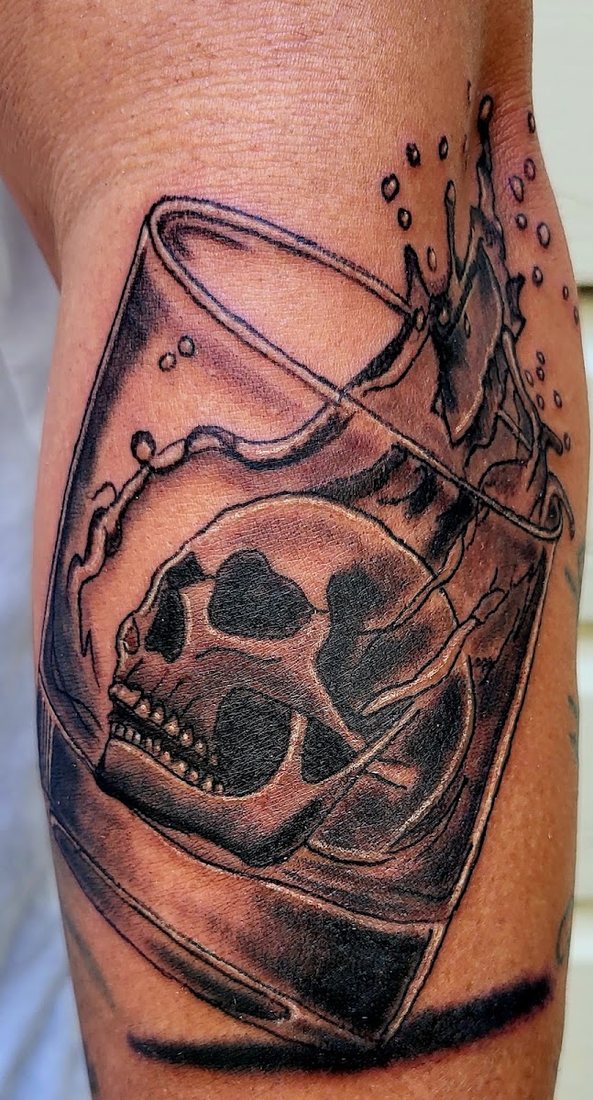 Black and gray skull in a glass by Billy at SK-Tattoo1 in Meridian, Mississippi